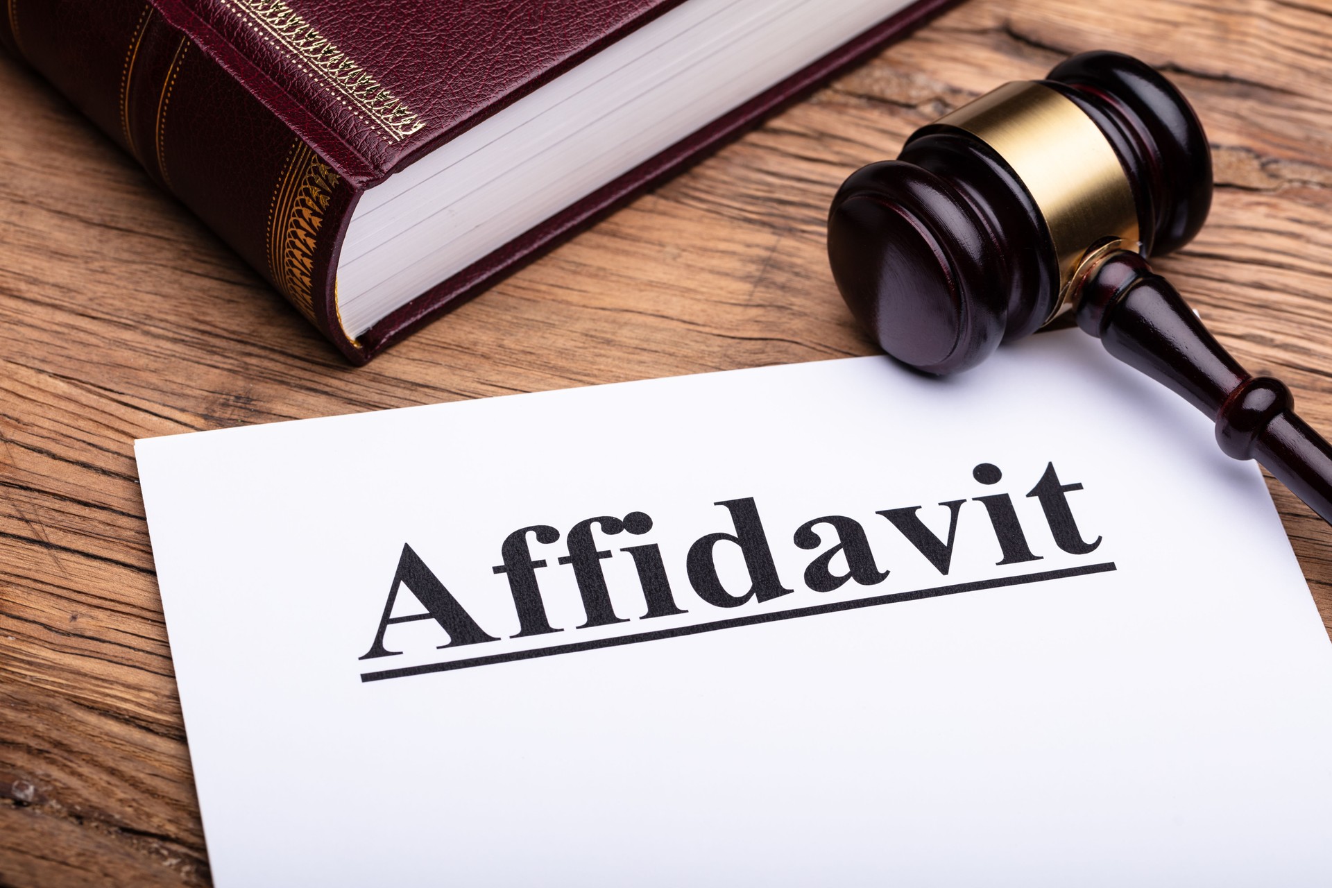Affidavit Form, Law Book And Gavel On Wooden Table